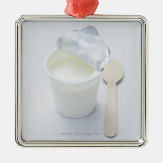 Yoghurt in opened disposable cup metal ornament