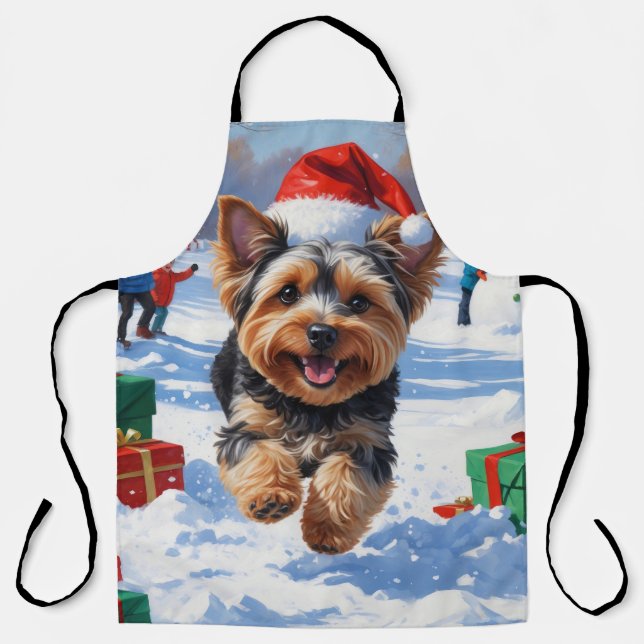 Yorkipoo Running in Snow with Christmas Hat Apron (Front)