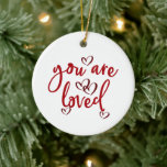 You Are Loved, Entwined Red Hearts Ceramic Ornament<br><div class="desc">This pretty ornament would make a nice gift for anyone that you love. It would make a great Valentine, anniversary, Mother's Day, Father's Day, birthdays or any time gift for anyone that has a special spot in your heart. It has red flowing decorative cursive text that says "You Are Loved"....</div>