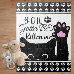 You Gotta Be Kitten Me Funny Cat Pattern Jigsaw Puzzle<br><div class="desc">Add a stylish cat touch to your home decor with this adorable cat jigsaw puzzle that says "You Gotta Be Kitten Me." The cat is black and is holding up one of its paws. There is also a background pattern of white paw prints. Touches of pink complete the kitty look....</div>