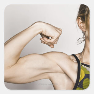 Young blond female flexes bicep muscle while square sticker