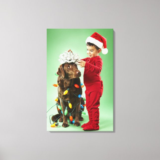 Young boy wrapping Christmas lights around a dog Canvas Print (Front)