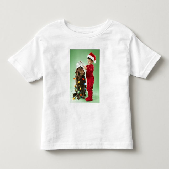 Young boy wrapping Christmas lights around a dog Toddler T-shirt (Front)
