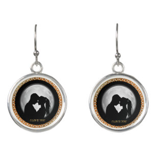 Young couple black silhouette kissing one another earrings