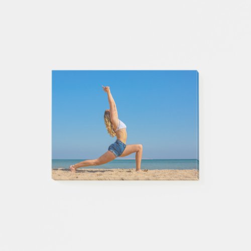 Young dutch woman in yoga posture on beachJPG Post_it Notes