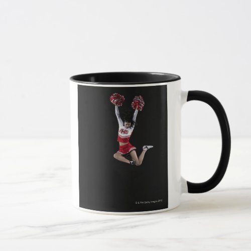 Young female cheerleader jumping in midair arms 2 mug