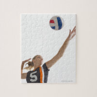 Young girl (16-17) playing volleyball