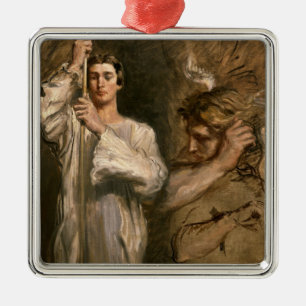 Young Man Holding a Cross Metal Ornament