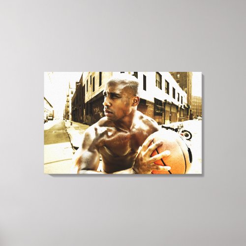 Young man holding basketball canvas print