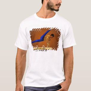 Young man practicing gymnastics on the pommel T-Shirt