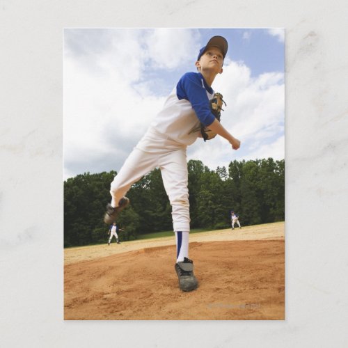 Young pitcher throwing baseball from mound postcard