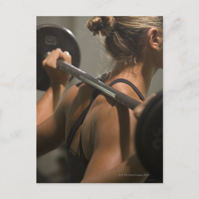 Young woman exercising with barbell, rear view postcard (Front)