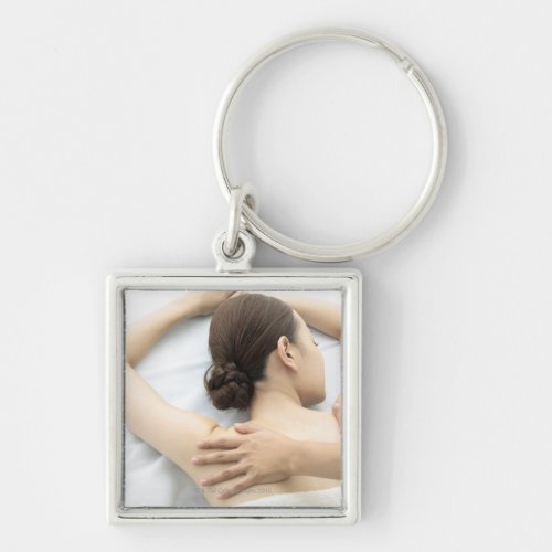 young woman receiving massagewoman in health 2 keychain