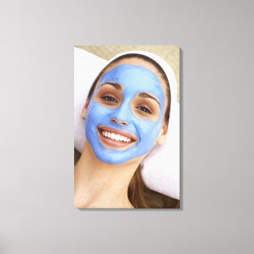 Young woman wearing facial mask smiling canvas print